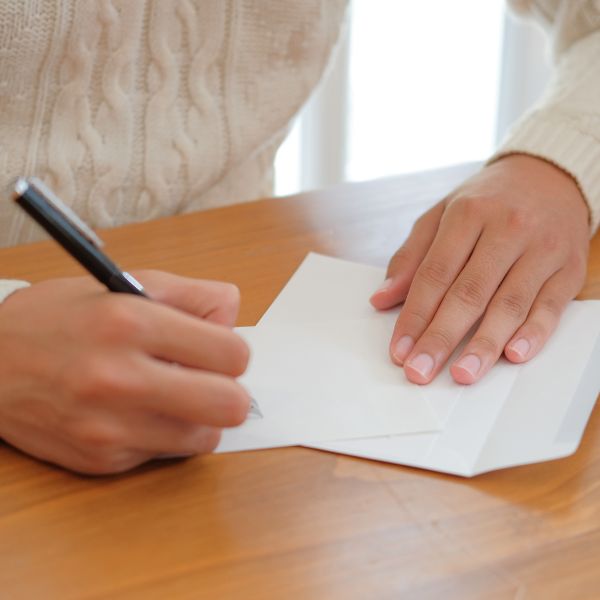 Person writing a letter