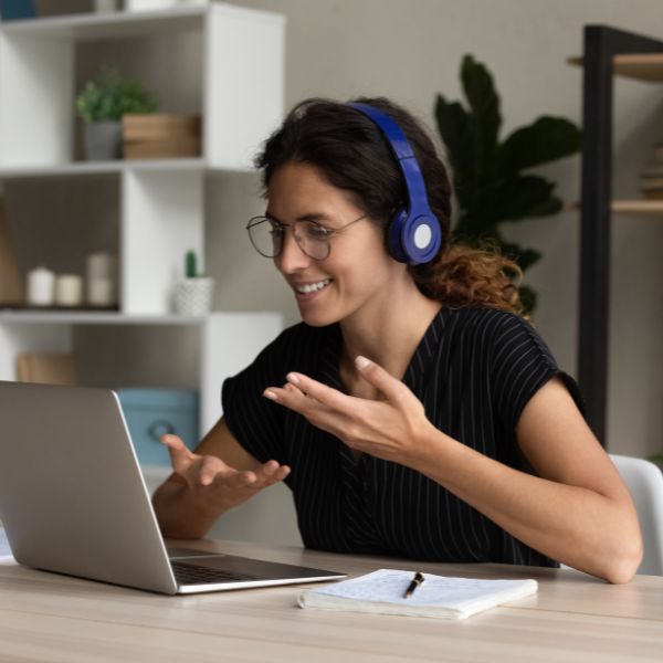 Happy woman having a video call on her laptop